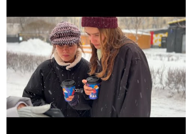 Russians look at pictures of destroyed Ukrainian city (Bakhmut)